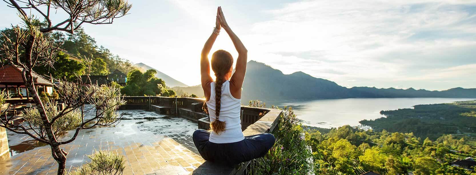 women doing yoga with island view in bali